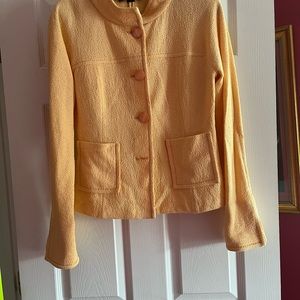 St. John peach colored jacket with 4 peach burton in the front.. size 8.